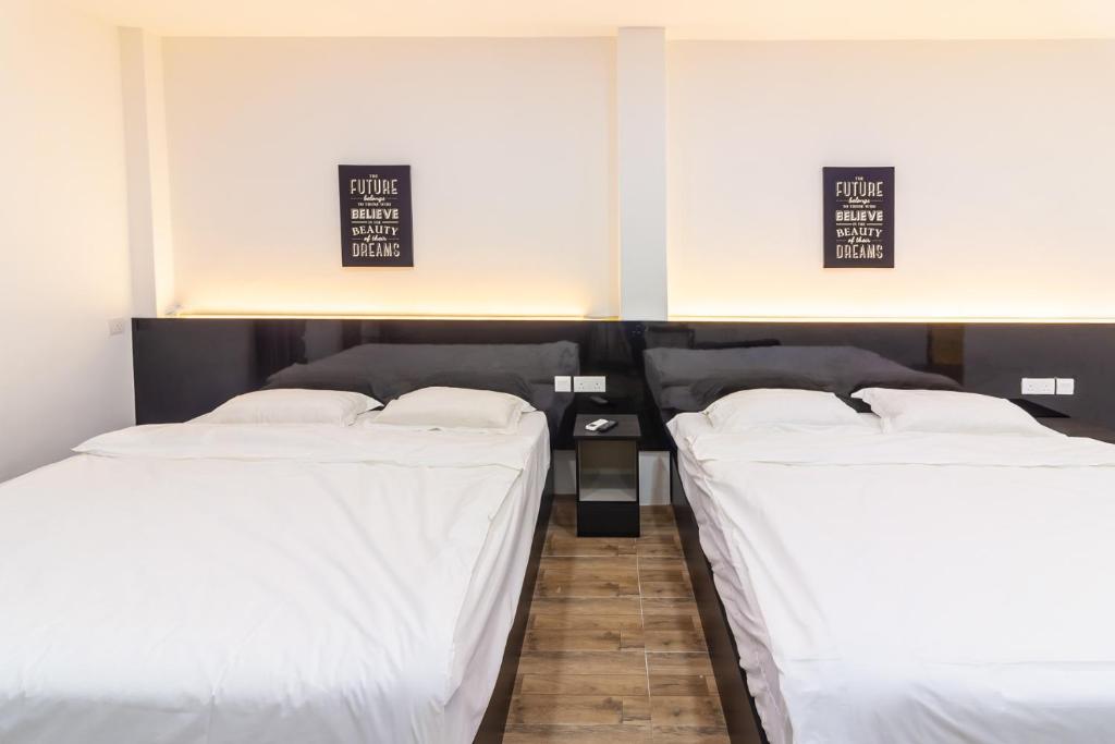 Postel nebo postele na pokoji v ubytování Tambun Warm Hotel