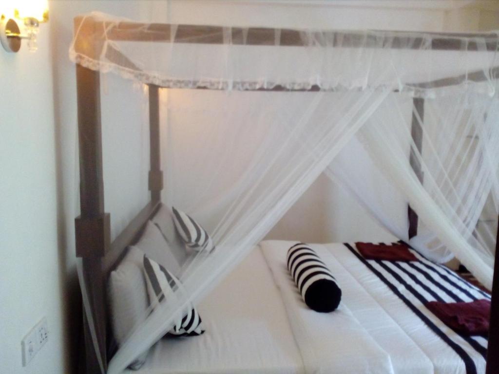 Postel nebo postele na pokoji v ubytování Forest Paddy Homestay