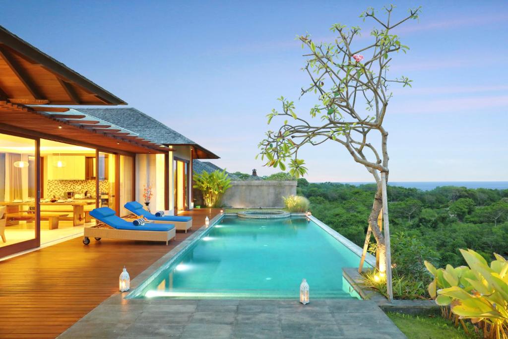 a swimming pool in the backyard of a house at Ocean View Villa Hotman Paris VII in Jimbaran