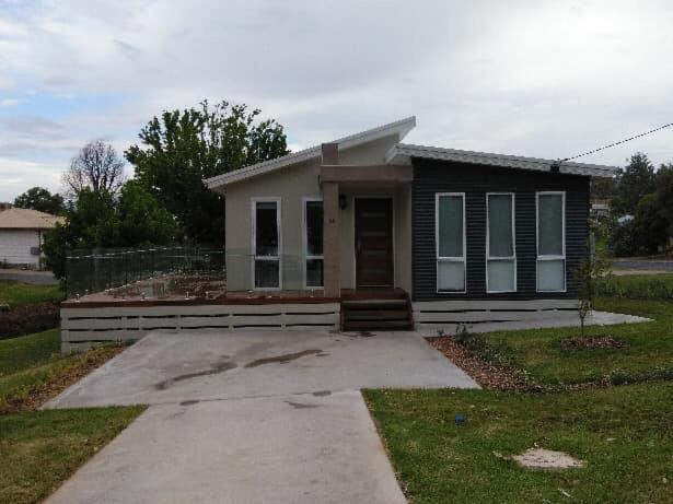 a small house with a driveway in front of it at All seasons holiday homes in Tumut