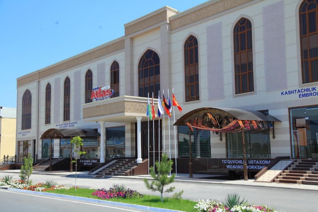 a large building with flags in front of it at Atlas in Margilan