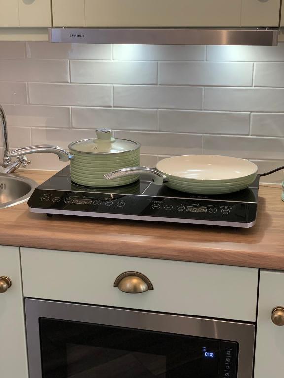 a stove with three dishes on top of it at Biddy Ban’s in Carnmalin