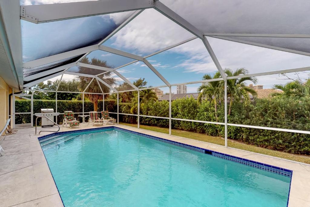 a swimming pool with a canopy over it at Marco Sands in Marco Island