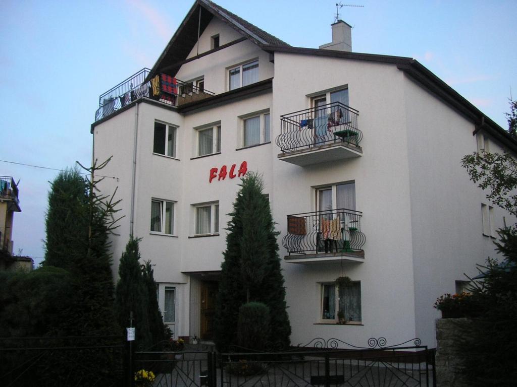 a large white building with balconies on it at DW FALA in Rewal