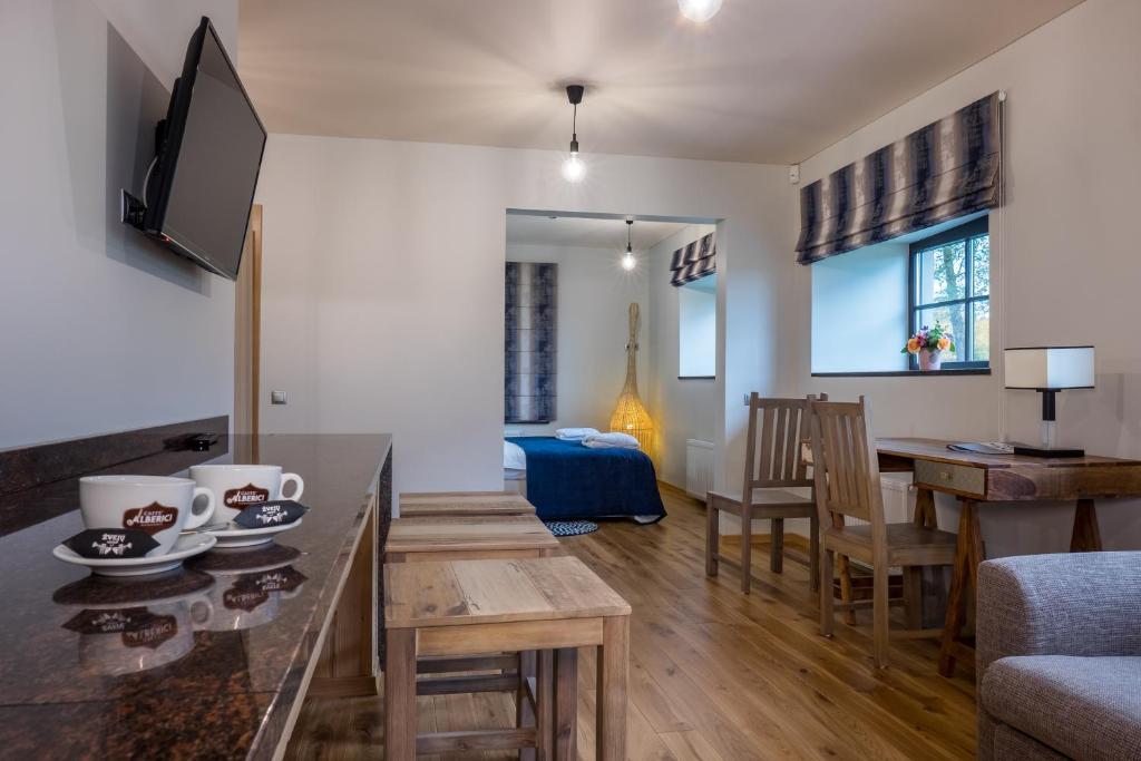 a living room with a table and a dining room at Žvejų užeiga in Šiauliai