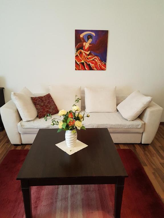 a living room with a coffee table and a couch at City Lodge Apartment in Leipzig