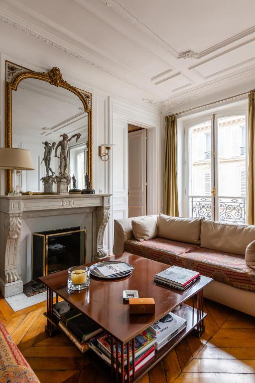 a living room with a couch and a fireplace at Veeve - Artistic in Pigalle in Paris