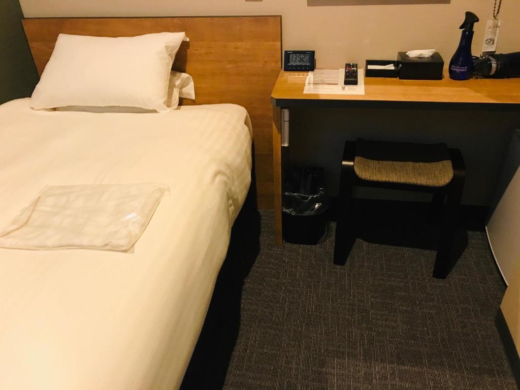 Postel nebo postele na pokoji v ubytování Kamon Hotel Seto