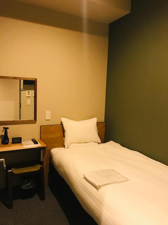 Postel nebo postele na pokoji v ubytování Kamon Hotel Seto