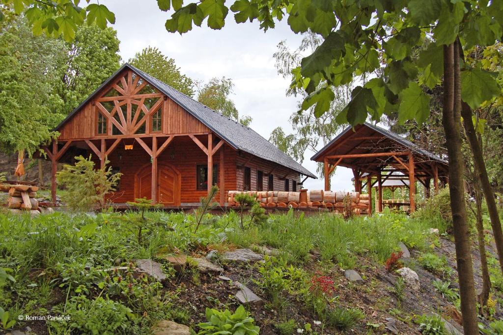 uma cabana de madeira na floresta com um alpendre em Kemp Indiana em Edrovice