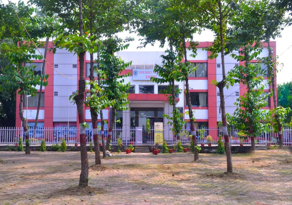 a building with a bunch of trees in front of it at MPT Tourist Motel, Dodi in Dodi