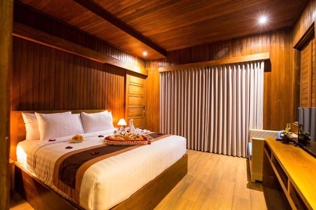 Postel nebo postele na pokoji v ubytování Seken Cottages Ubud