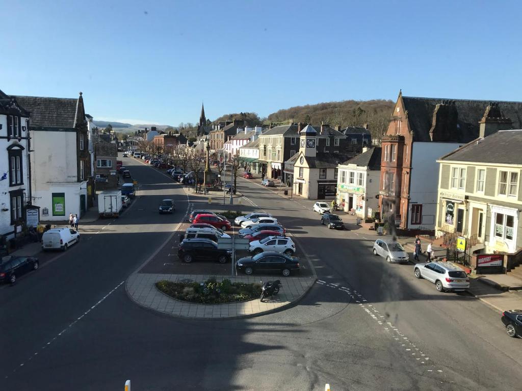 a city street with cars parked in a parking lot at Home with a view in Moffat