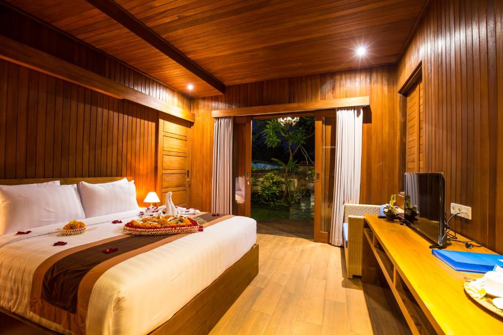 Postel nebo postele na pokoji v ubytování Seken Cottages Ubud