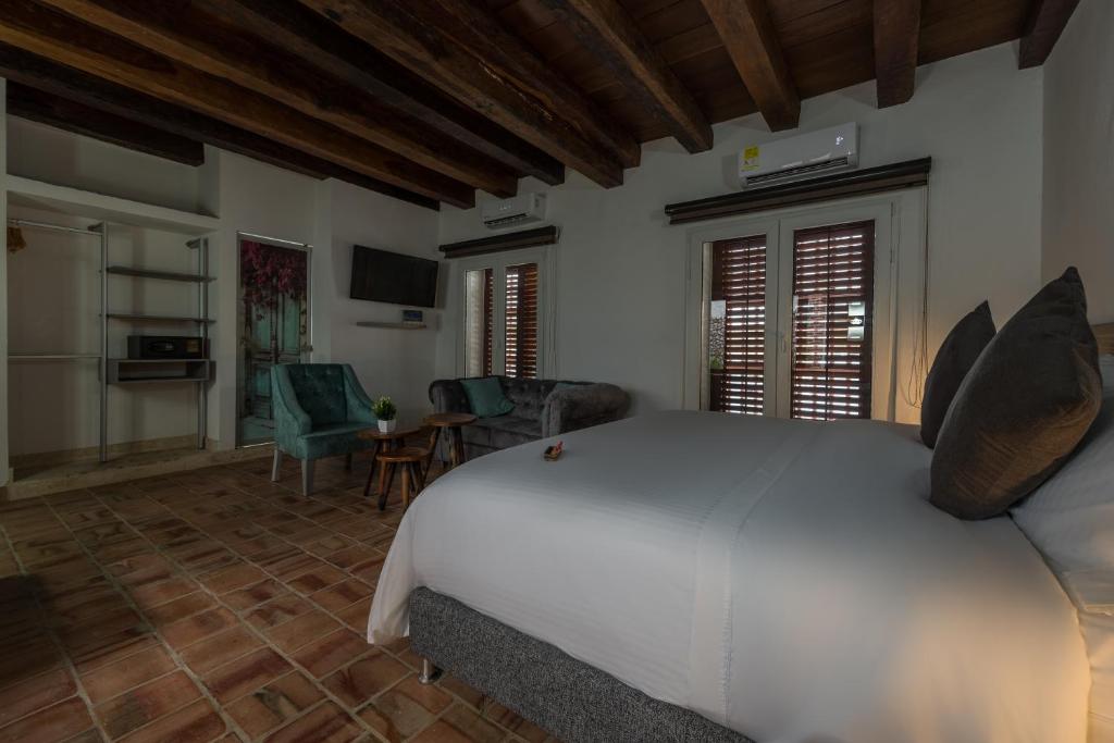 Postel nebo postele na pokoji v ubytování Getsemani Cartagena Hotel