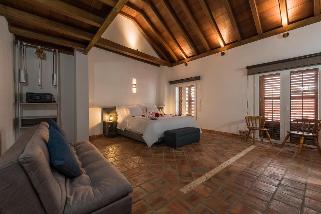 Postel nebo postele na pokoji v ubytování Getsemani Cartagena Hotel