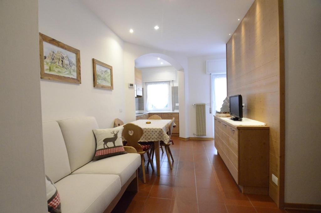 a living room with a couch and a table at Continental 102 - 4 beds in San Vito di Cadore