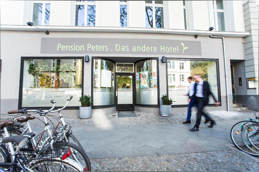 a man and woman walking in front of a store at Pension Peters – Das andere Hotel in Berlin