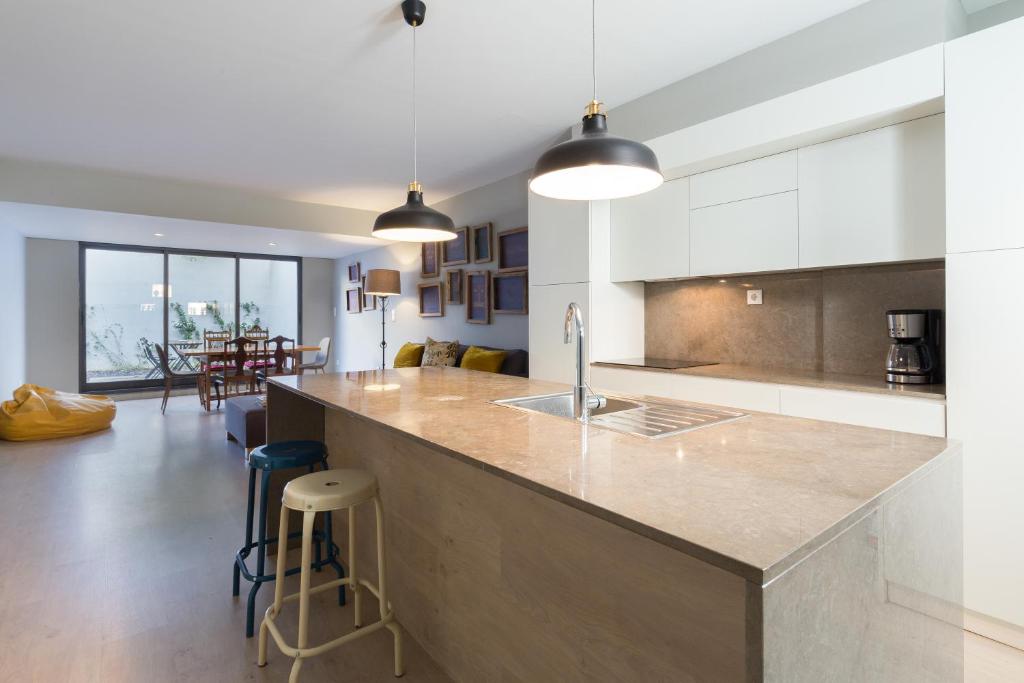 a kitchen with a large island with a counter top at Porto Home by PCALE in Porto