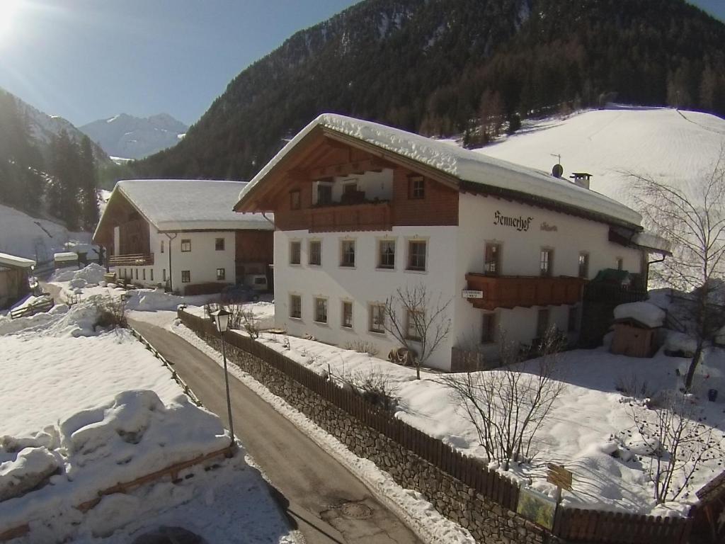 a house in the snow with a mountain at Sennerhof in Racines