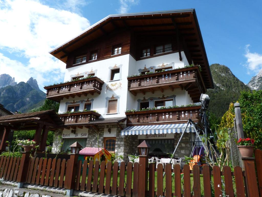 a building with a clock on the top of it at Al Sole in Auronzo di Cadore