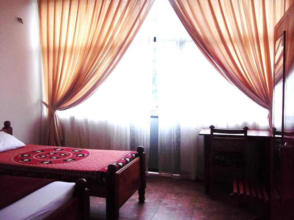 Postel nebo postele na pokoji v ubytování Majestic Tourist Hotel