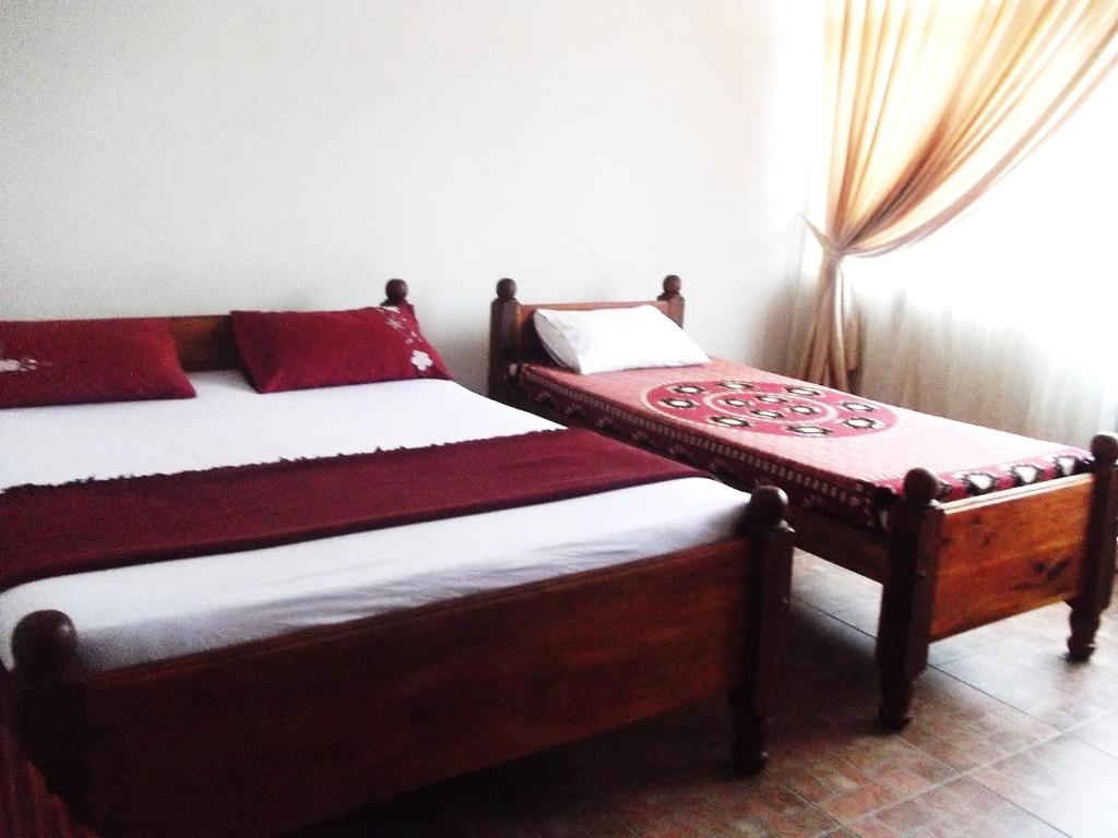 Postel nebo postele na pokoji v ubytování Majestic Tourist Hotel