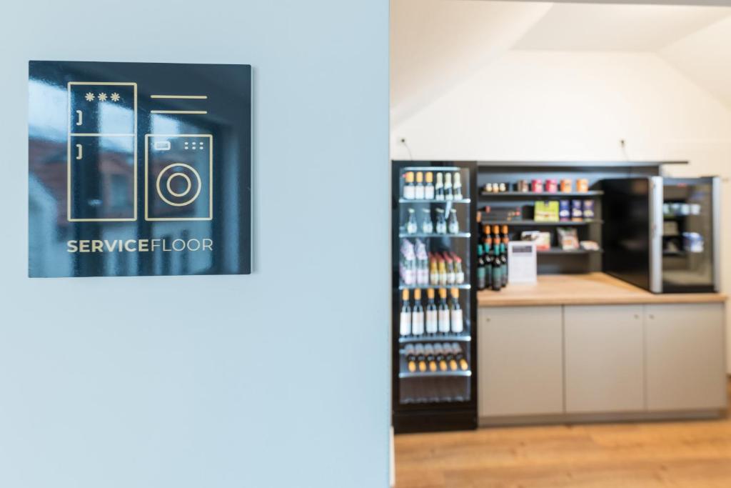 a room with a counter with a camera on the wall at Suites MITTE - Aparthotel in Eisenach