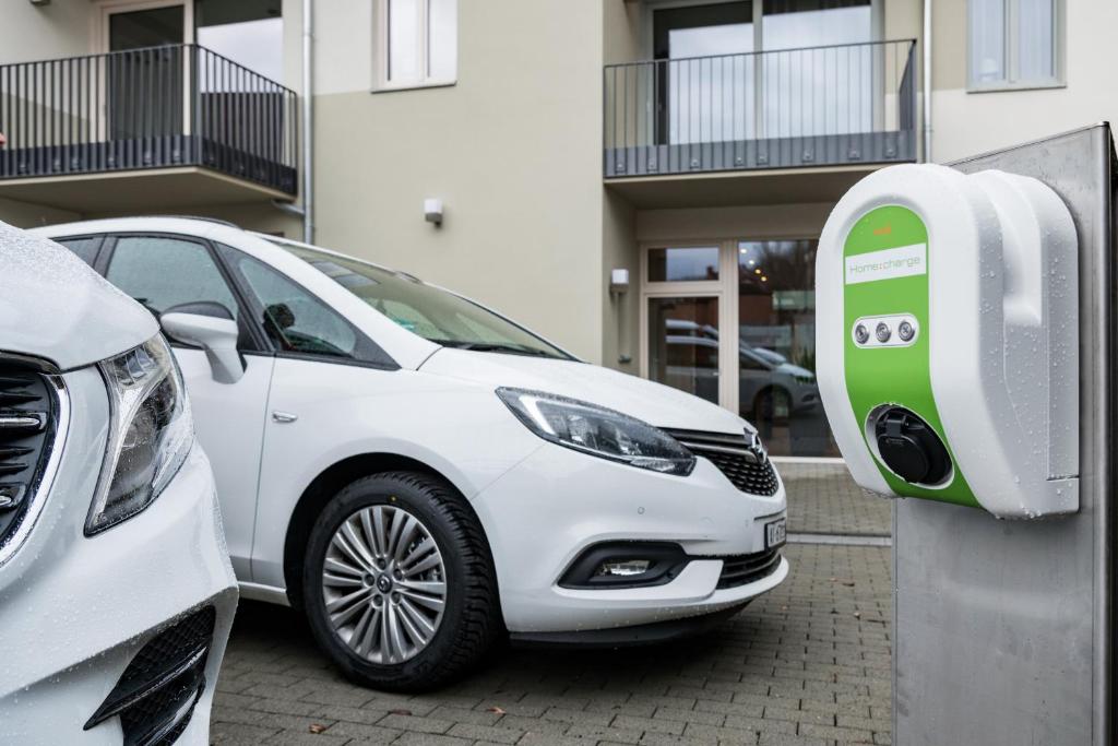 a white car is parked next to a parking meter at Suites MITTE - Aparthotel in Eisenach