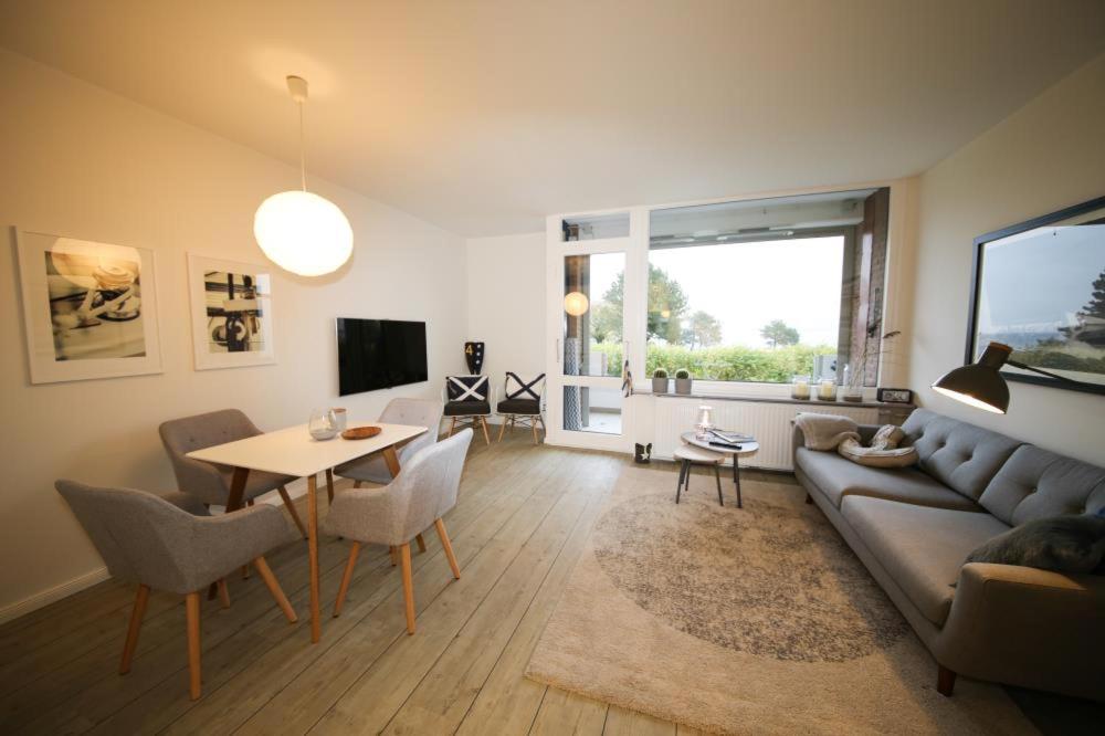 a living room with a couch and a table at Ferienwohnung Kaiserblick in Travemünde