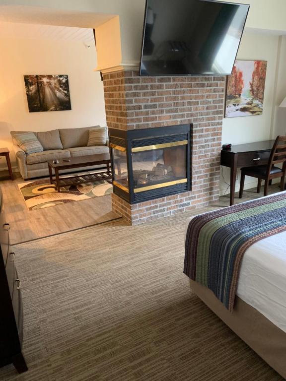 a living room with a fireplace and a couch at McCoy's Inn in Ripley