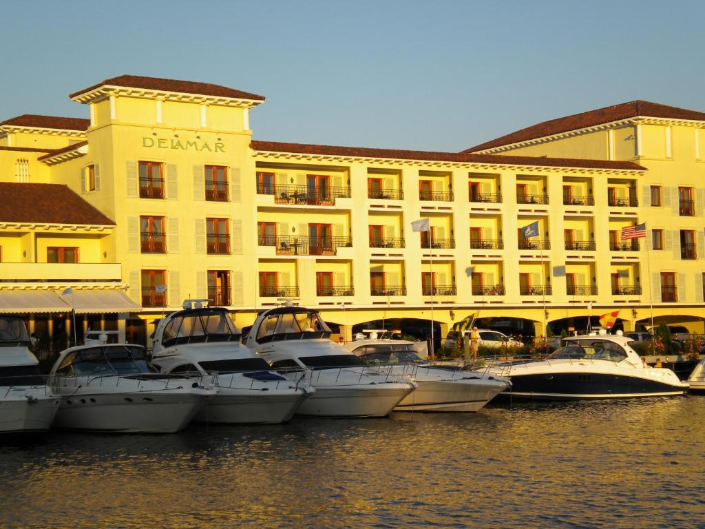 a group of boats in the water in front of a building at Delamar Greenwich Harbor in Greenwich