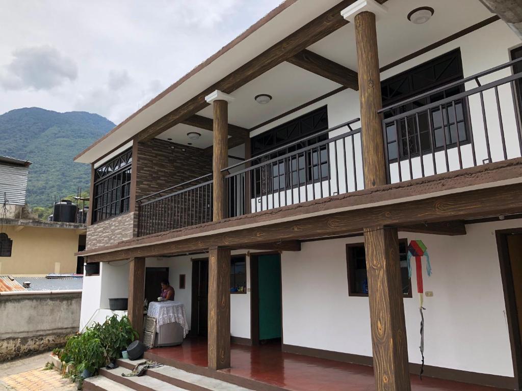 a building with a balcony and a table on a patio at Casa Imelda, Atitlan in Sololá