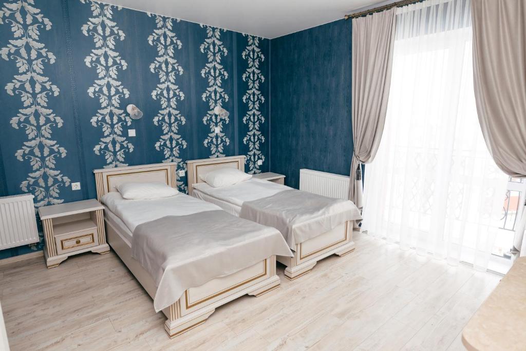 Postel nebo postele na pokoji v ubytování Triumph