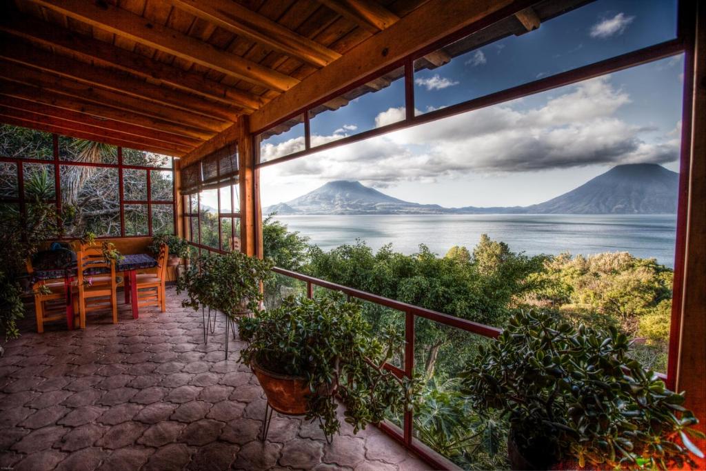 a house with a balcony with a view of the ocean at Casa Wenche in Santa Cruz La Laguna