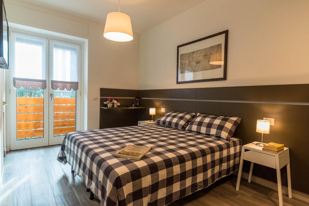 Postel nebo postele na pokoji v ubytování parina Inn – Locanda