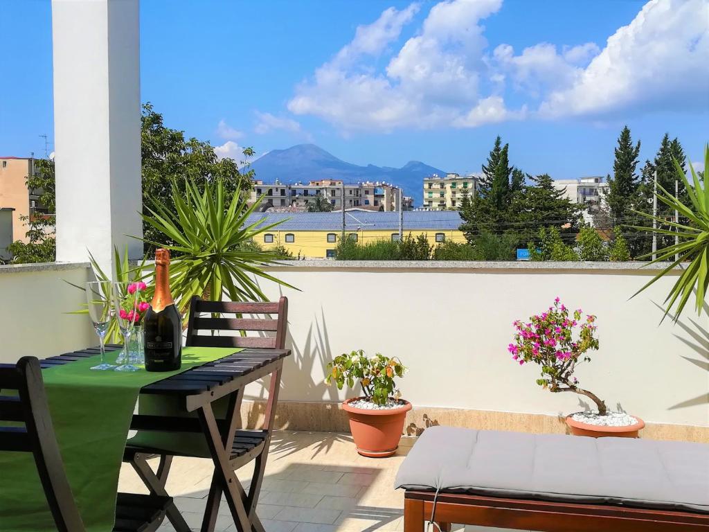 a table and chairs on a balcony with a view at Zefiro B&B in Pompei