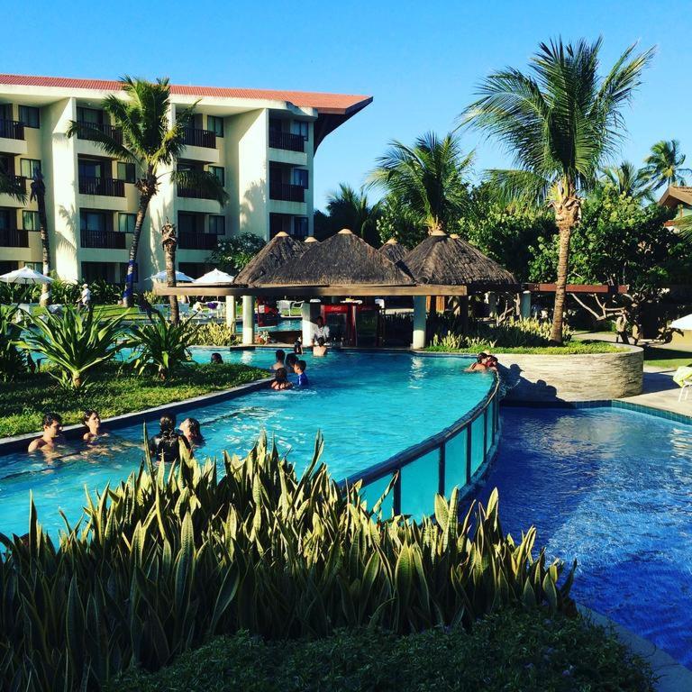 a group of people in a swimming pool at a resort at Marulhos Resort by Smart Stays in Porto De Galinhas
