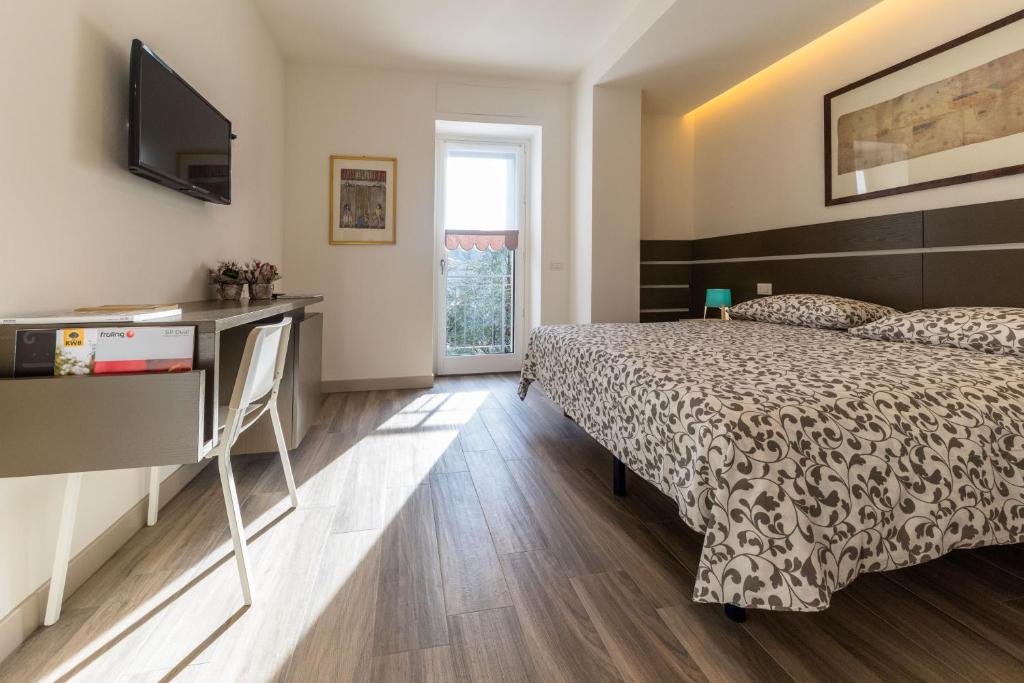 Postel nebo postele na pokoji v ubytování parina Inn – Locanda
