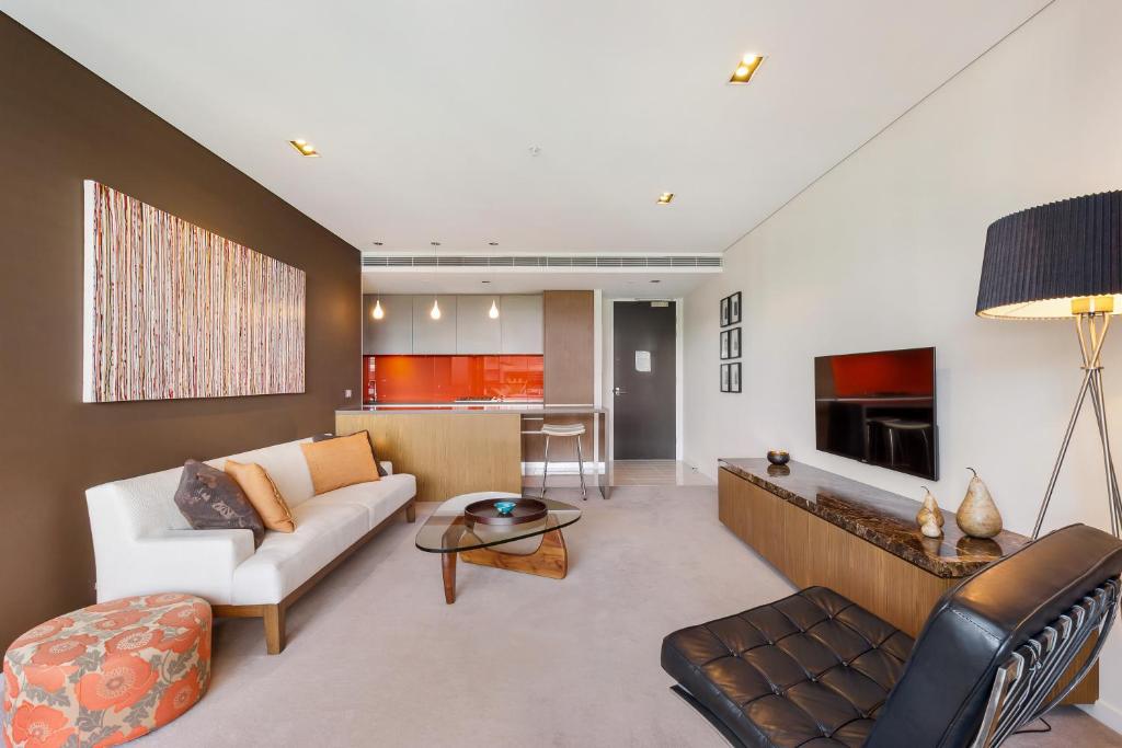 a living room with a couch and a table at Stylish 1 bdrm Camperdown - Car park, Gym & Pool in Sydney