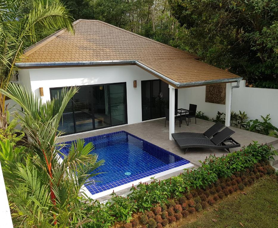 a swimming pool in the backyard of a house at Exotic Boutique Hotel in Khao Lak