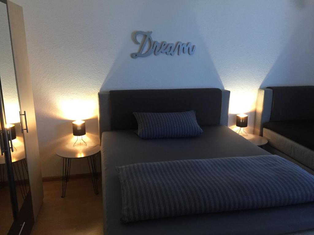 a bedroom with a bed with the word dreameria on it at Apartment Simone in Lörrach