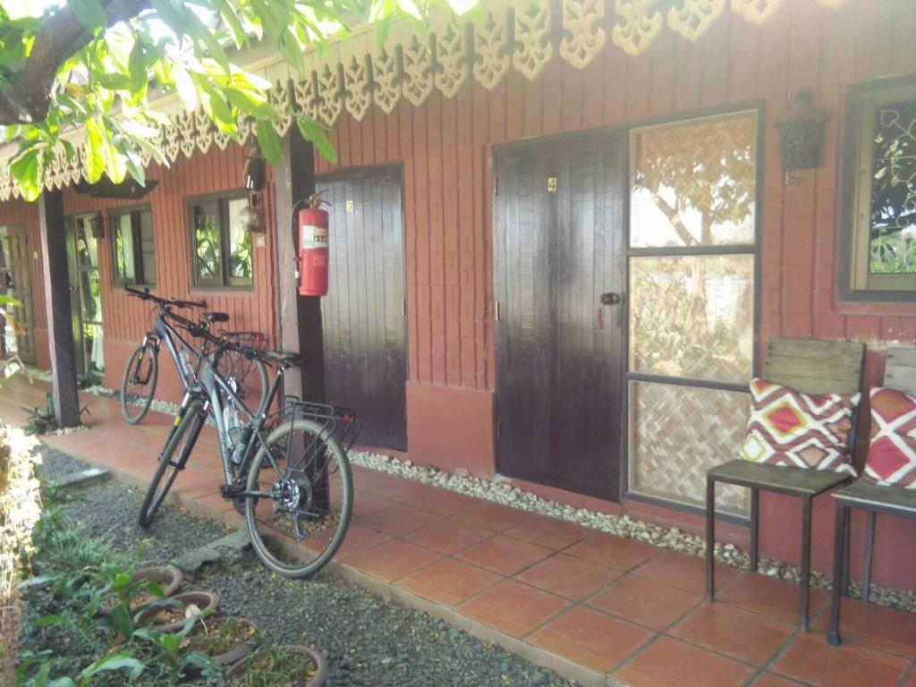 a bike parked in front of a house at Rim Than View Resort in Ubon Ratchathani