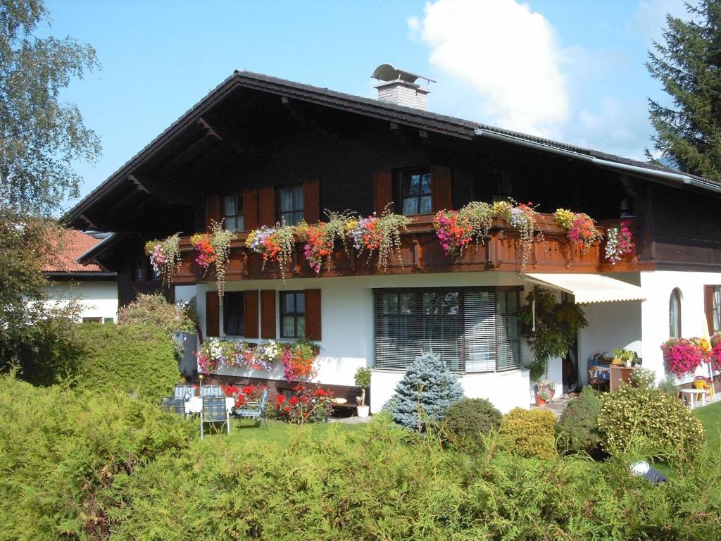 a house with lots of flowers on the balcony at Landhaus Tripolt in Radstadt