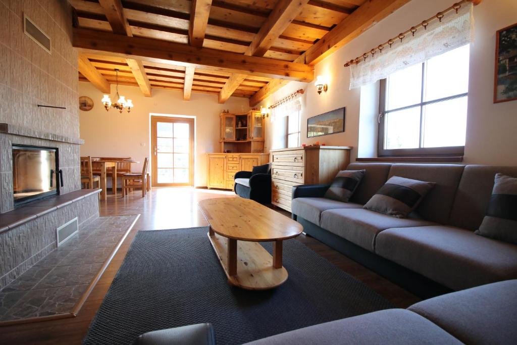 a living room with a couch and a table at Chata u Mikiho Krahule in Krahule