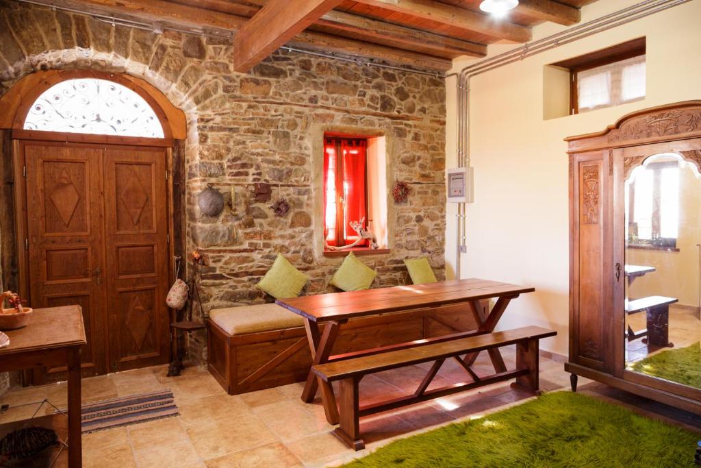 a room with a wooden door and a table at "Iali" Cottage House in Kanália