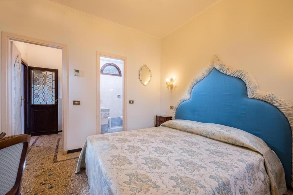 Postel nebo postele na pokoji v ubytování Hotel Giorgione