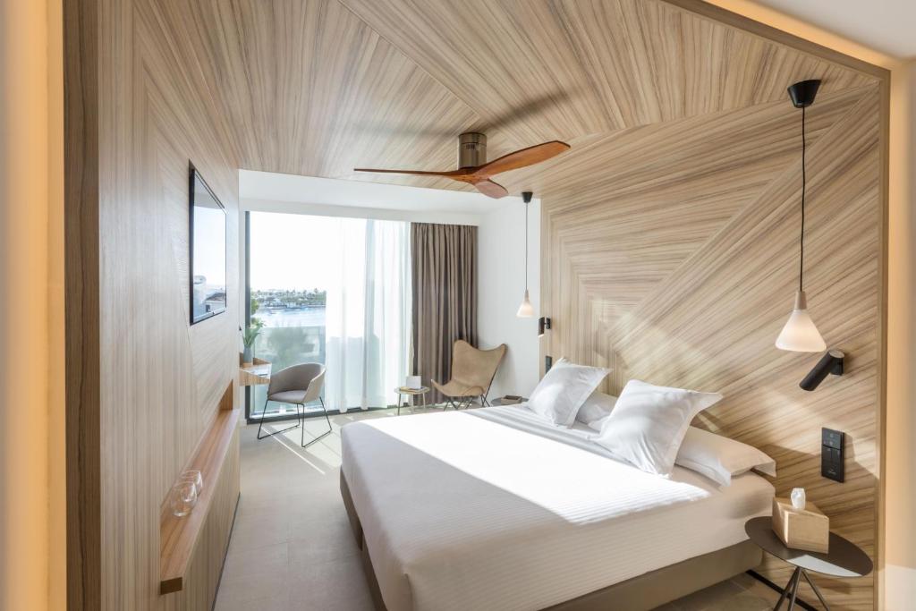 A bed or beds in a room at Bordoy Alcudia Port Suites - Adults Only