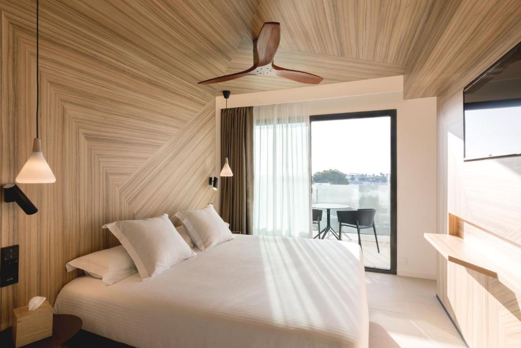 A bed or beds in a room at Bordoy Alcudia Port Suites - Adults Only
