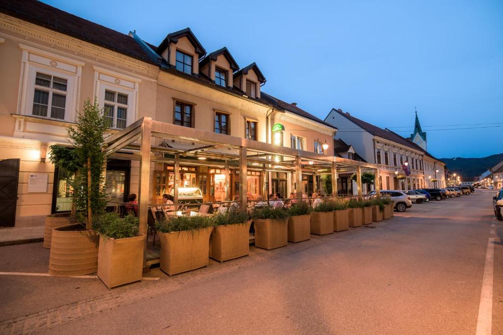 a city street with a row of shops on either side of it at Hotel Splavar in Brežice